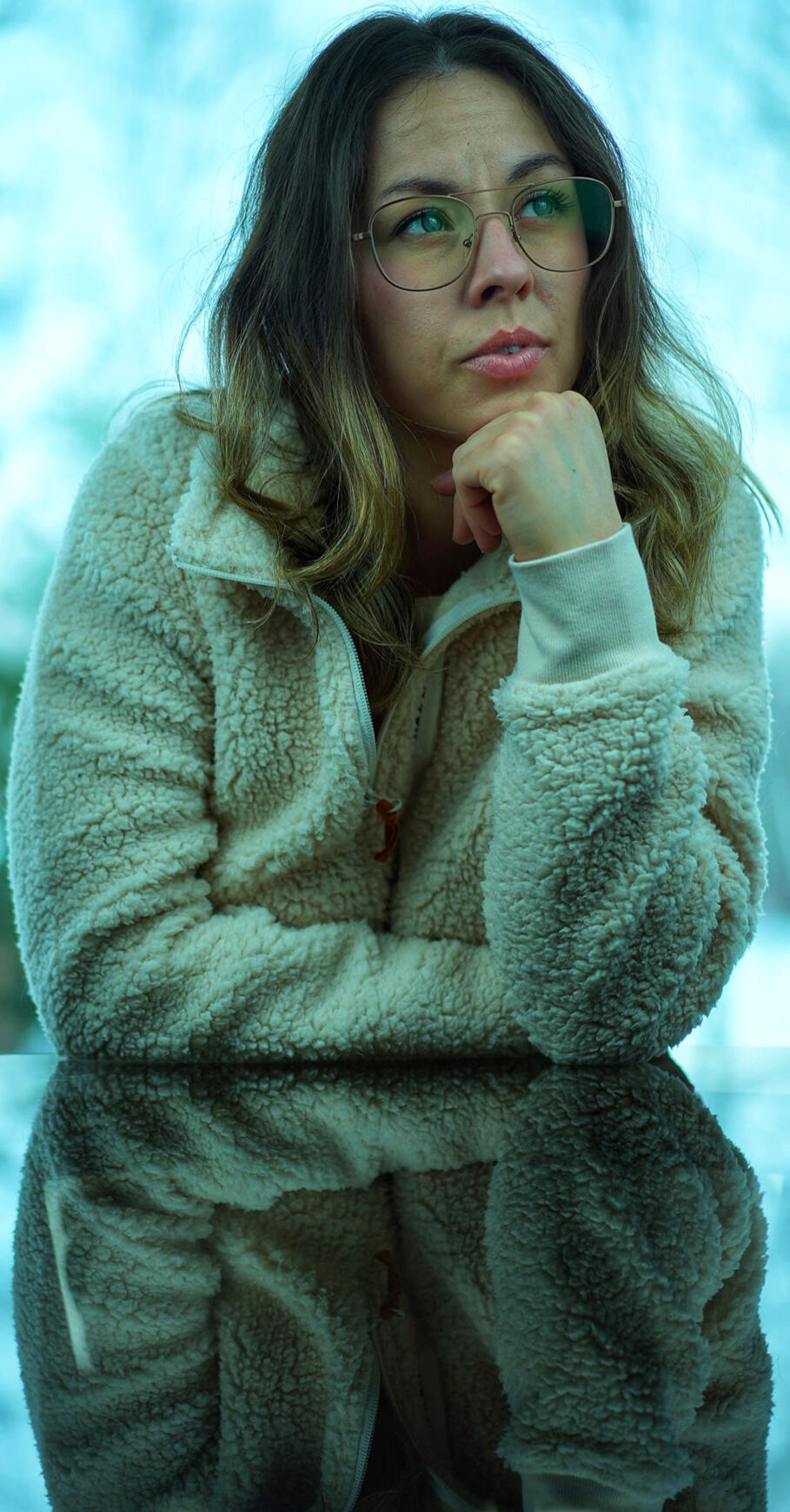 Candid Reflection of Caitlin Maracle A serene and thoughtful moment captured with Caitlin Maracle, the creative mind behind Killer Satyr. Pictured in a cozy fleece jacket, with her chin resting gently on her hand, she gazes off into the distance, exuding calm confidence and inspiration. he so
